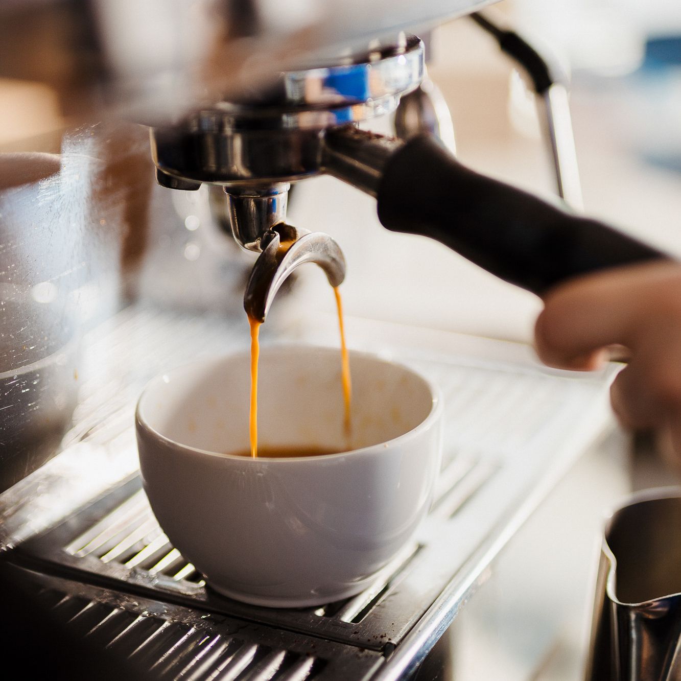 Espresso pouring from a machine into a Waynes cup